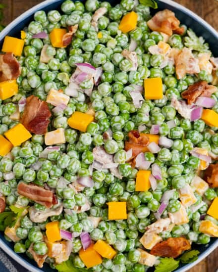 This classic pea salad is made with crisp tender sweet peas, crunchy red onion, salty bacon, creamy cheese cubes, and a sweet and tangy dressing. It's the perfect side dish to bring to a spring/summer potluck, holiday or a family dinner, and it's easy to make ahead as well!
