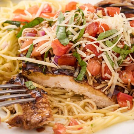 This bruschetta chicken pasta combines marinated and grilled chicken, topped with a fresh summer bruschetta, and served with a light white wine pasta. It’s a great spring and summer dinner idea that the whole family will love!