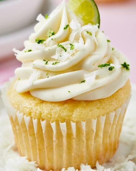 These coconut cupcakes are the perfect blend of fluffy, soft, and moist! They're topped off with a mouthwatering lime cream cheese frosting, and absolutely perfect for any summer celebrations! Garnish with lime zest and coconut, or decorate with holiday colors.