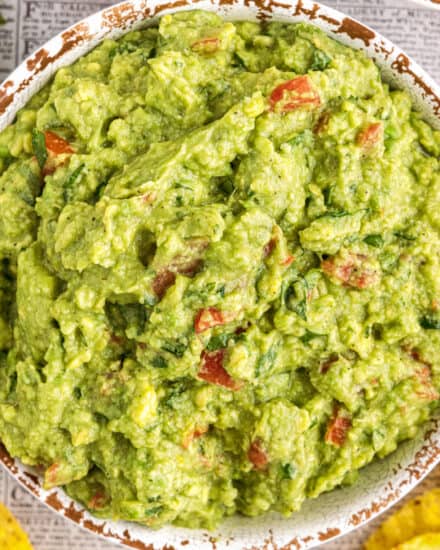 Don't reach for that container of pre-made guacamole, mix up this easy and classic guacamole recipe in no time! Made with simple ingredients, this dip comes together quickly and is a party staple. Put out a bowl with some chips, and watch it disappear!