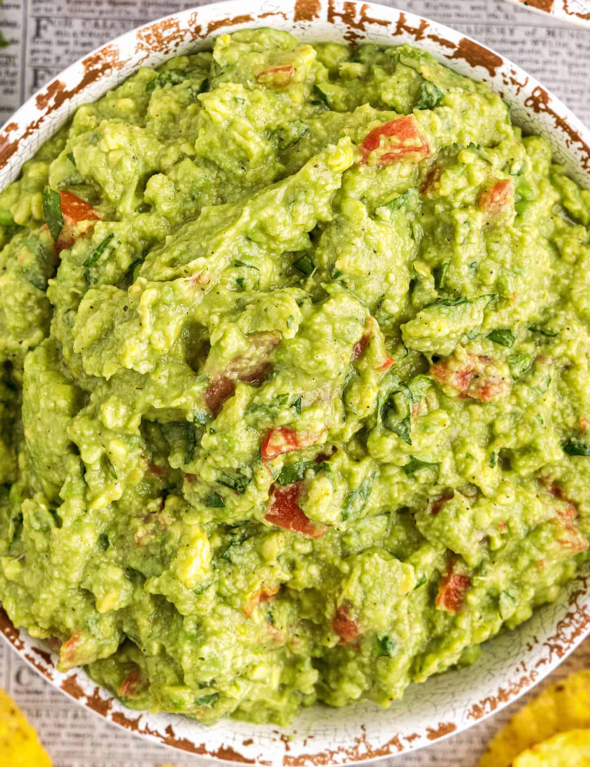 Don't reach for that container of pre-made guacamole, mix up this easy and classic guacamole recipe in no time! Made with simple ingredients, this dip comes together quickly and is a party staple. Put out a bowl with some chips, and watch it disappear!