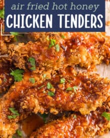 Juicy chicken tenders are coated with a crunchy cornflake breading, air fried until perfectly golden, then liberally drizzled with a sweet and spicy homemade hot honey sauce!