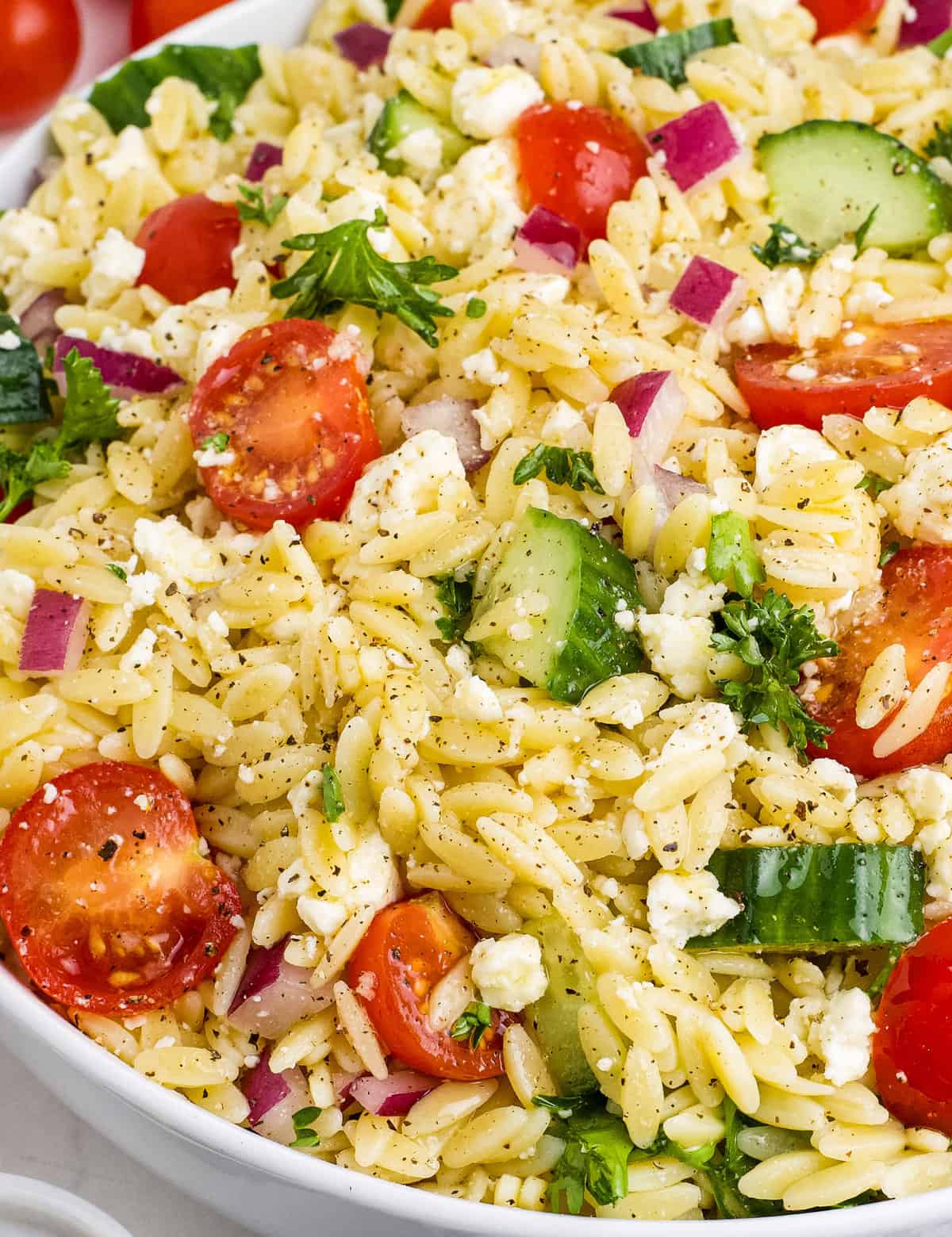 This light and easy to make lemon orzo salad is the perfect make-ahead pasta salad. Made with a tangy and slightly sweet lemon vinaigrette, this side dish is full of fresh produce like cucumbers and cherry tomatoes and packed with bold, yet simple flavors.