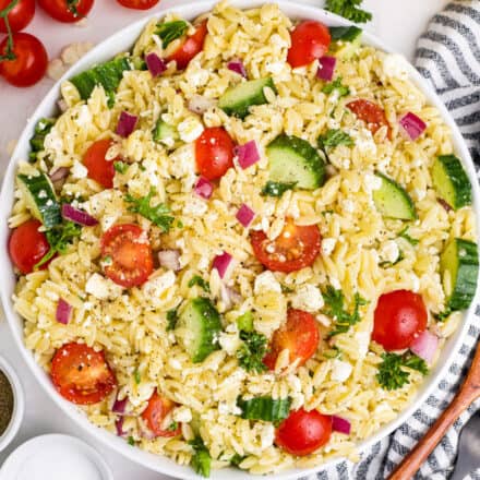 overhead photo of orzo salad with lemon and feta in a white bowl.