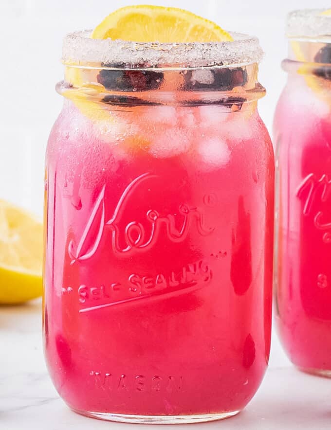 Cool down with the ultimate summer drink... blackberry lemonade! ย Homemade blackberry syrup is mixed with refreshing lemonade, then topped off with a sugared rim and a few garnishes. Plus, it's made with only 4 ingredients (including water)!