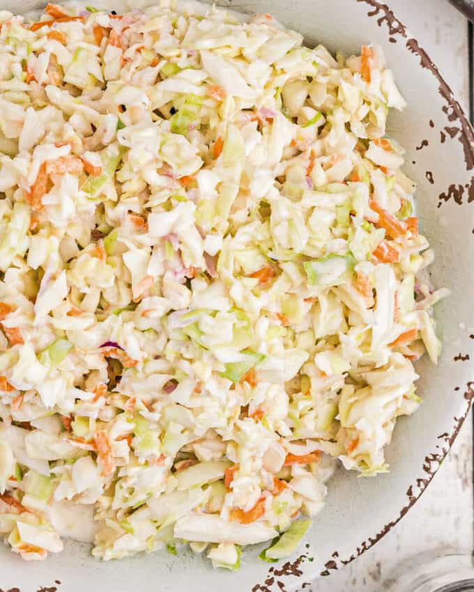 kfc-style coleslaw with cabbage and carrots in a white serving bowl.