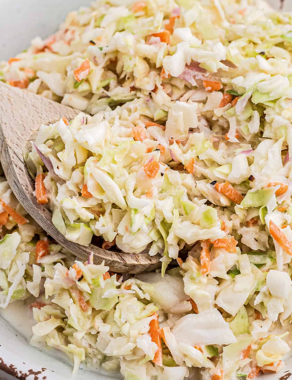 This simple Copycat KFC Coleslaw Recipe is made with crisp cabbage and carrots in a creamy, sweet and tangy buttermilk dressing! Perfect to make ahead, bring to a cookout as a side dish, or on top of a bbq sandwich!