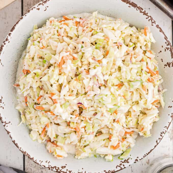 overhead photo of coleslaw in a distressed white bowl