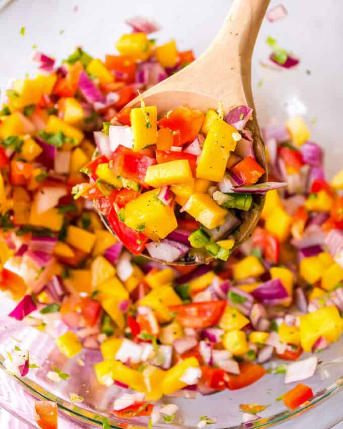 wooden spoonful of mango salsa.