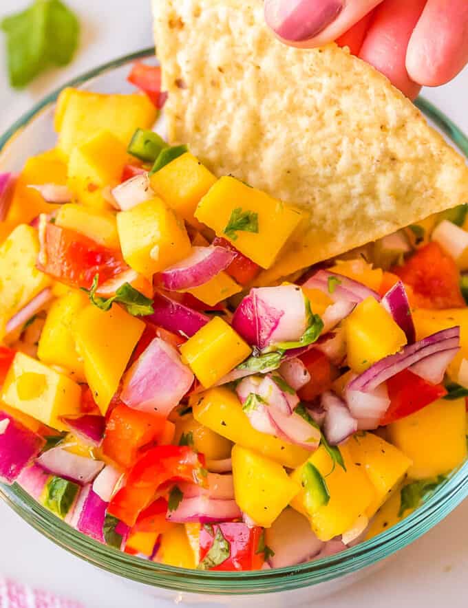 This fresh salsa is made with juicy ripe mangos, spicy jalapeño peppers, crisp red onion, and more! Mango salsa is the perfect accompaniment to your seafood, chicken, or pork tacos!