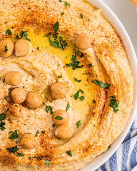 This homemade hummus recipe is creamy, light, and much better than store-bought. Using canned chickpeas eliminates the need for any soaking or peeling, so you can dip your pita chips or vegetables in this delicious dip in no time!