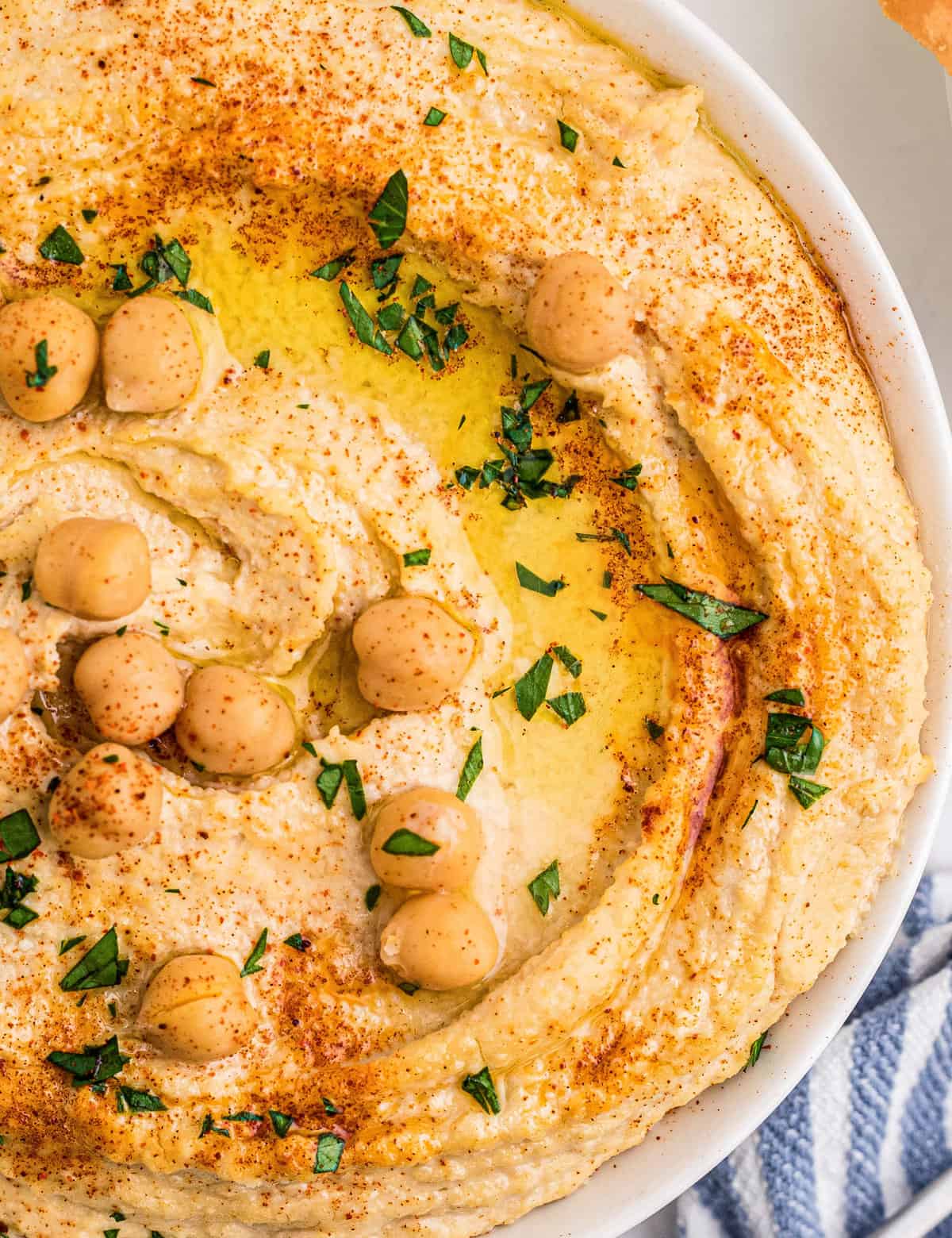 This homemade hummus recipe is creamy, light, and much better than store-bought. Using canned chickpeas eliminates the need for any soaking or peeling, so you can dip your pita chips or vegetables in this delicious dip in no time!