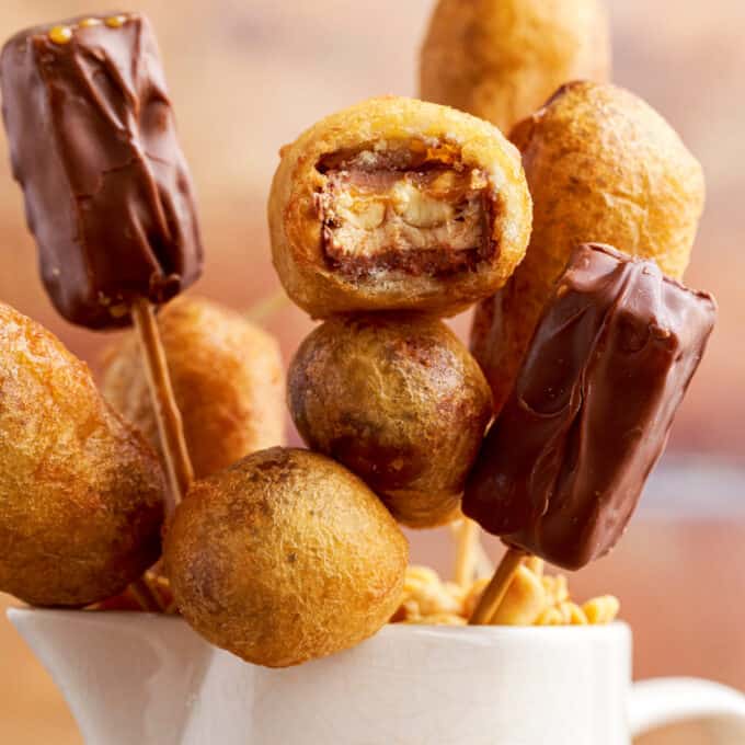 bouquet of fried snickers bars with a bite taken out of one.