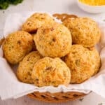 towel-lined bread basket filled with cheddar biscuits.