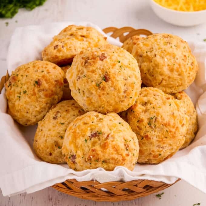 towel-lined bread basket filled with cheddar biscuits.