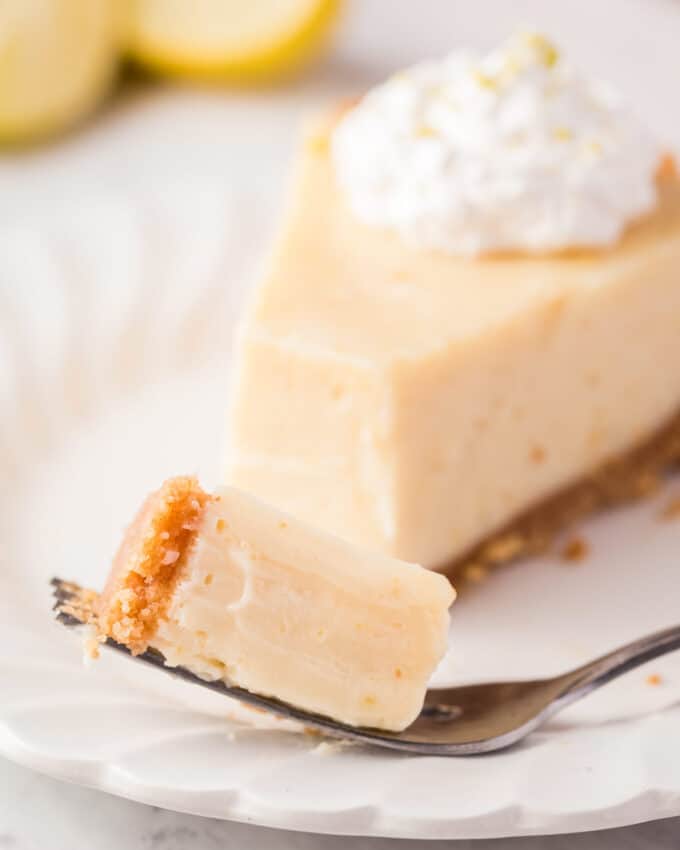 forkful of lime pie on white plate.