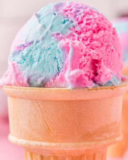 Rich and creamy ice cream is flavored with cotton candy extract, and dyed vibrant "cotton candy style" colors, for a fun summer dessert. This frozen treat is so simple to make, and no ice cream maker is required!