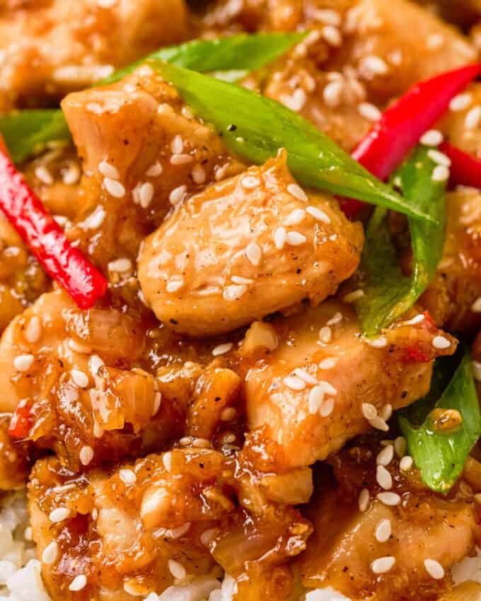 Close up view of honey pepper chicken on a bed of rice.