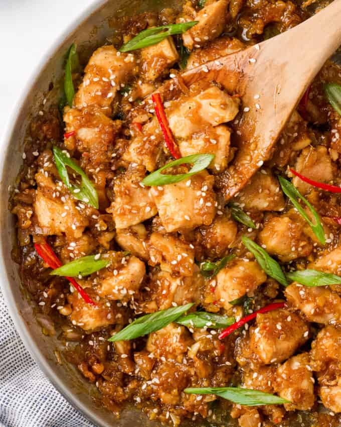 Overhead photo of a stainless steel skillet full of black pepper chicken.