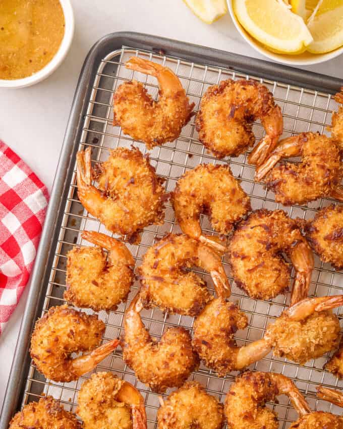 overhead photo of coconut shrimp on wire cooling rack.
