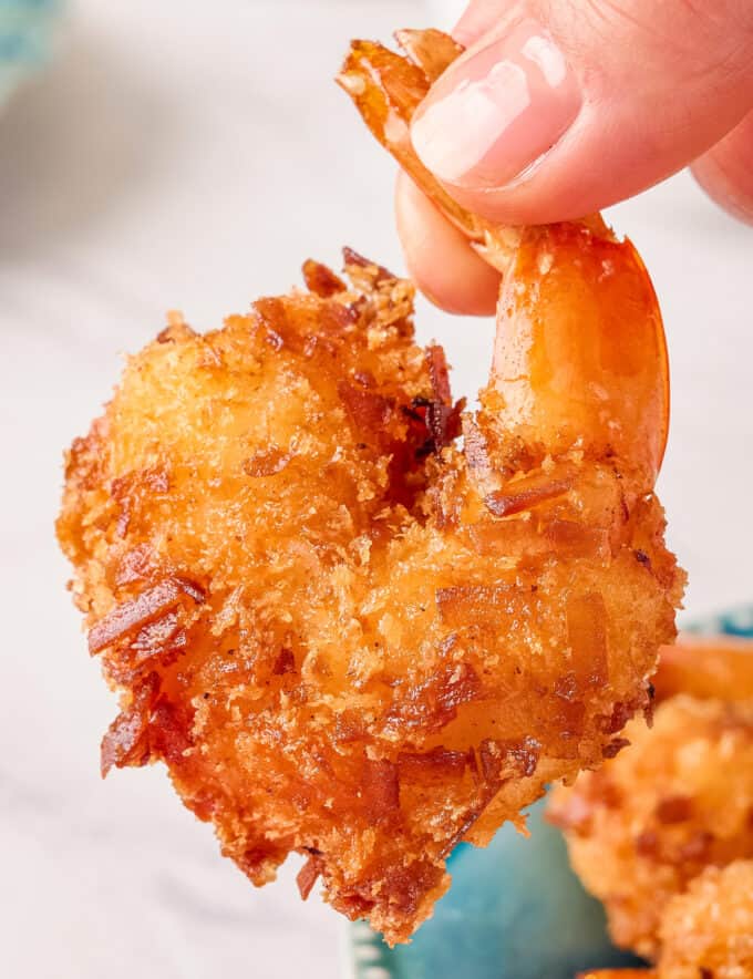 Fried coconut shrimp are made with a crunchy golden brown, slightly sweet coating, fried until perfectly crisp on the outside and juicy inside. Pair them with a spicy and sweet horseradish marmalade sauce and you'll have a mouthwatering tropical seafood dinner or appetizer!
