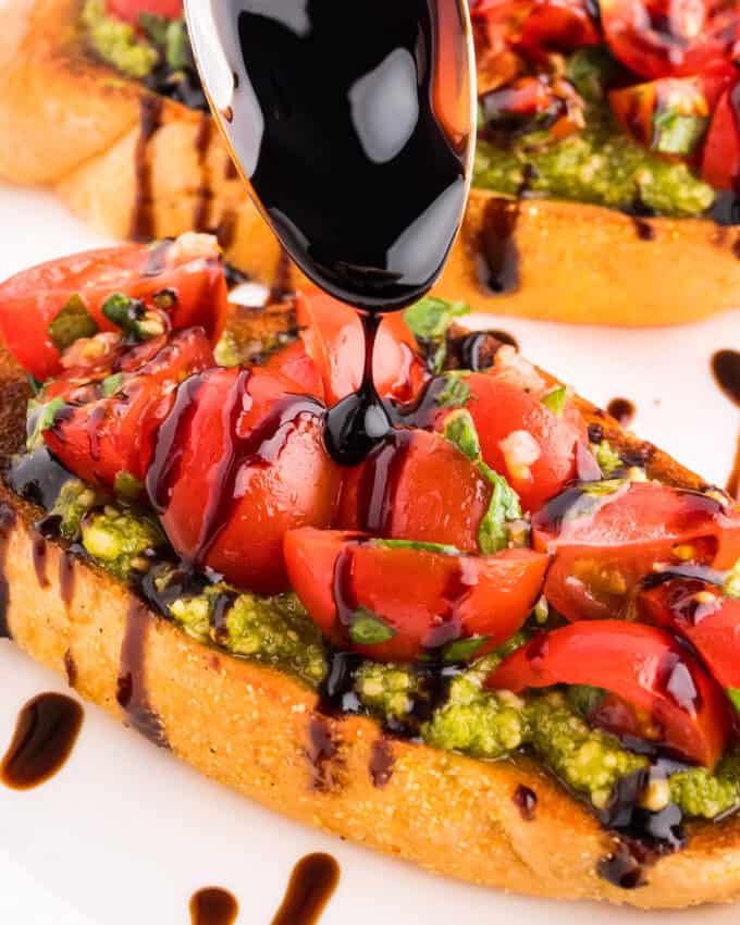 drizzling balsamic glaze over pesto and tomato bruschetta.