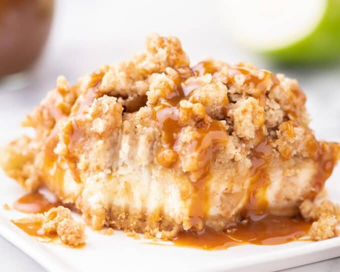 caramel apple cheesecake bar with a forkful taken out of it.