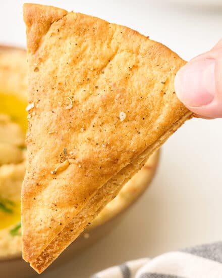 Skip the bag of thin unsatisfying pita chips from the grocery store and make your own homemade baked pita chips at home! They'll be a fraction of the price, and SO much more flavorful.