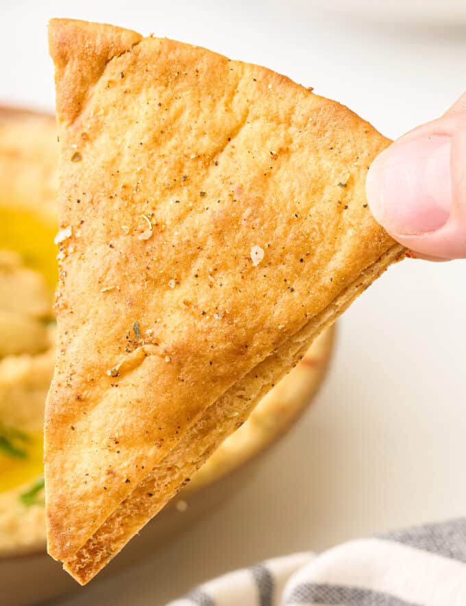 Skip the bag of thin unsatisfying pita chips from the grocery store and make your own homemade baked pita chips at home! They'll be a fraction of the price, and SO much more flavorful.