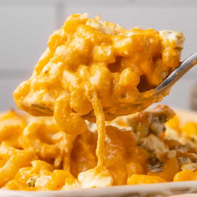 scooping out a serving spoonful of buffalo chicken mac and cheese.