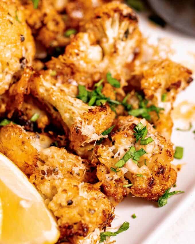 close photo of a cheesy roasted cauliflower floret.