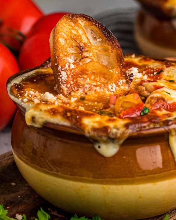 This Deluxe Pizza Soup is brimming with all the flavors of a classic and cheesy deluxe or supreme pizza, but in comforting soup form! Perfect for a weeknight meal, it can be served as a regular soup, or topped with crostini and cheese and baked until gooey and melted (like French onion soup).