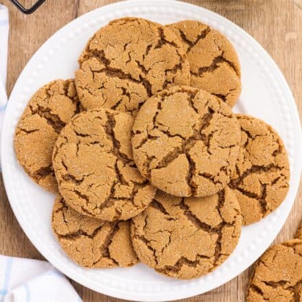 pile of molasses cookies on a white plate.