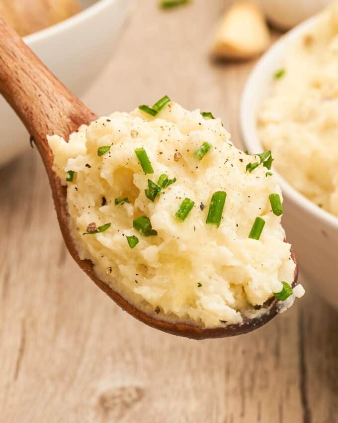 scoop of mashed potatoes garnished with fresh chives and parsley.