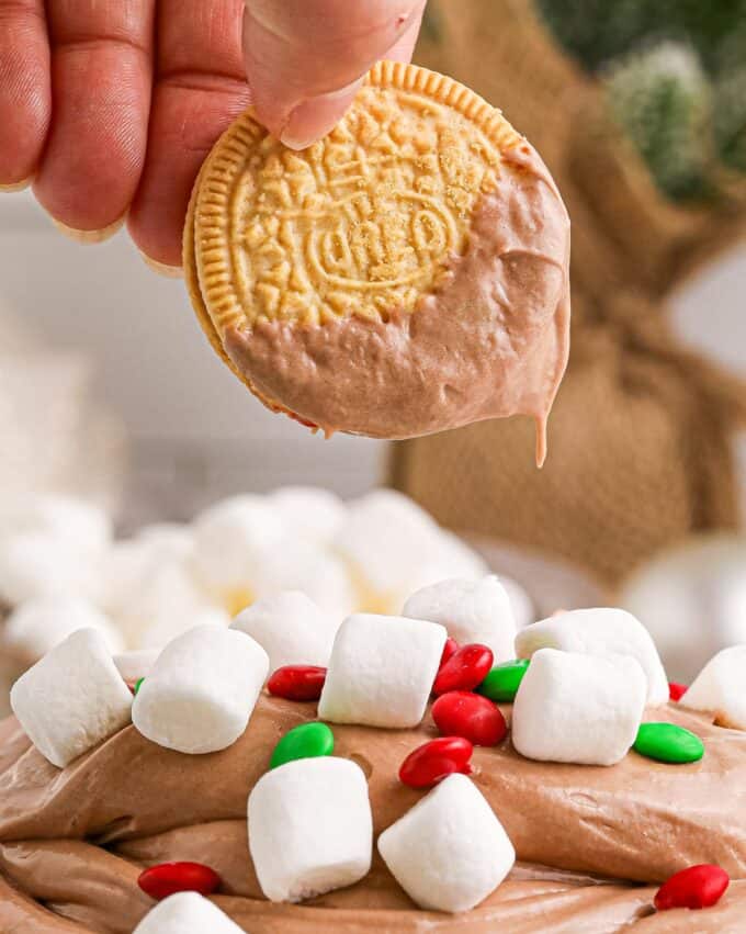 a white oreo dipped in hot chocolate dip