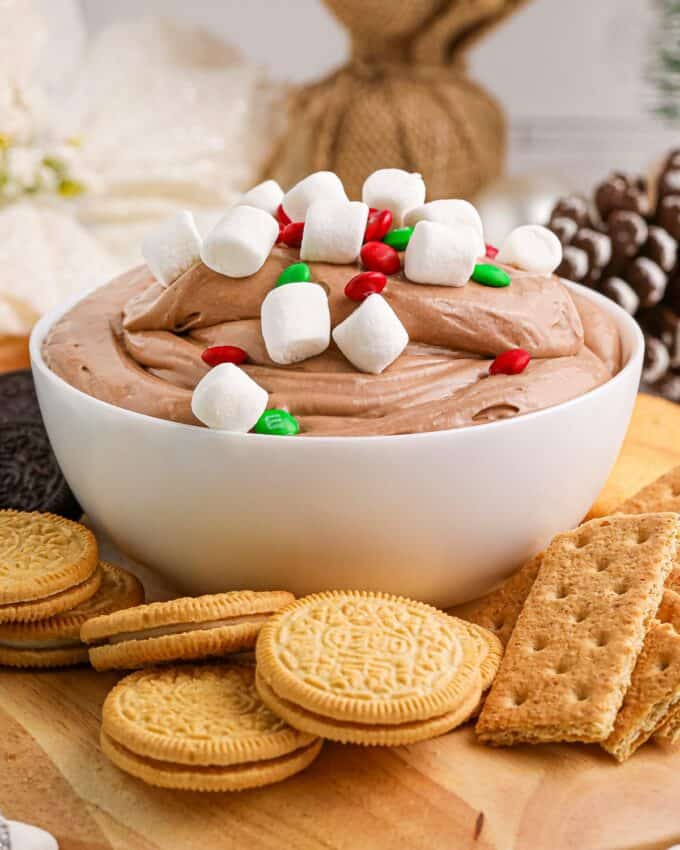 hot chocolate dip in a bowl, surrounded by cookies and crackers.