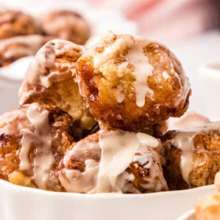 pile of cinnamon sugar monkey bread bites in a white bowl.