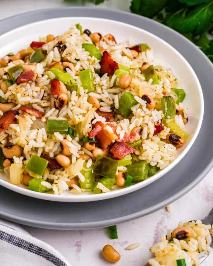 This Southern comfort food is typically eaten on New Year's Day for good luck, but I think it's delicious all year round! Made with black-eyed peas, veggies, bacon, white rice, and a blend of savory spices, this recipe is hearty enough for a main dish, but also works great as a side!