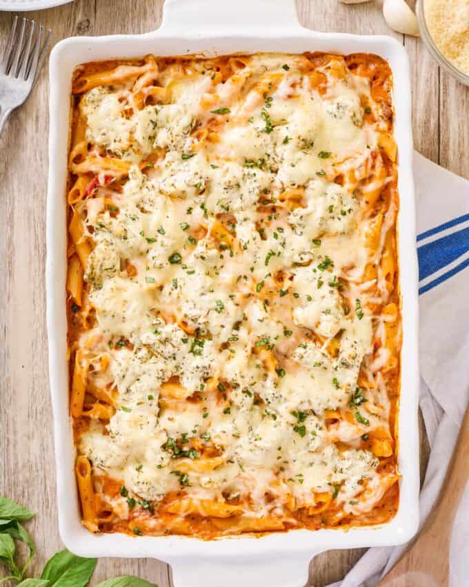 baking dish filled with baked penne with a layer of melted cheese on top.
