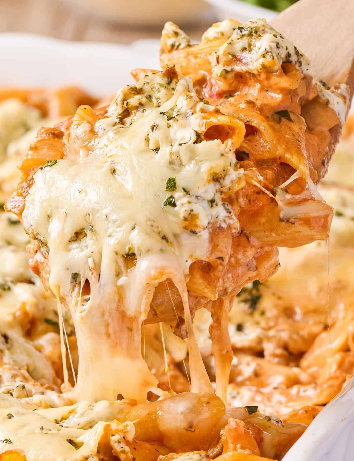 This creamy baked penne recipe is loaded with meaty and cheesy deliciousness! Perfect as a freezer meal or a big family dinner, this pasta bake is made with al dente pasta, a creamy marinara meat sauce, herbed cream cheese, and plenty of mozzarella and Parmesan!