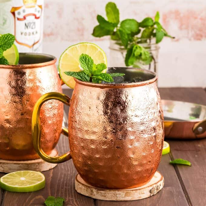 table set with two copper mugs of moscow mule