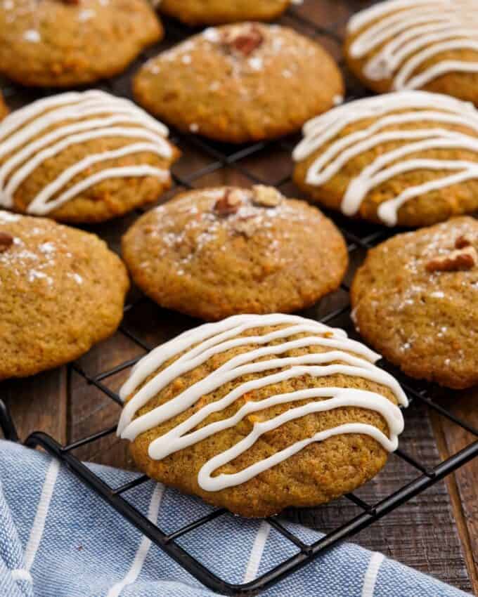 These soft and tender carrot cake cookies are perfect with just a dusting of powdered sugar, or a decadent drizzle of cream cheese frosting! They're so moist and the perfect Easter or Spring dessert!