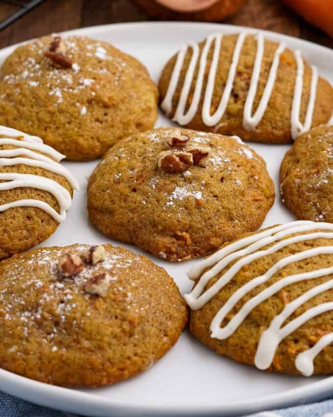 carrot cake cookies drizzled with frosting on a plate