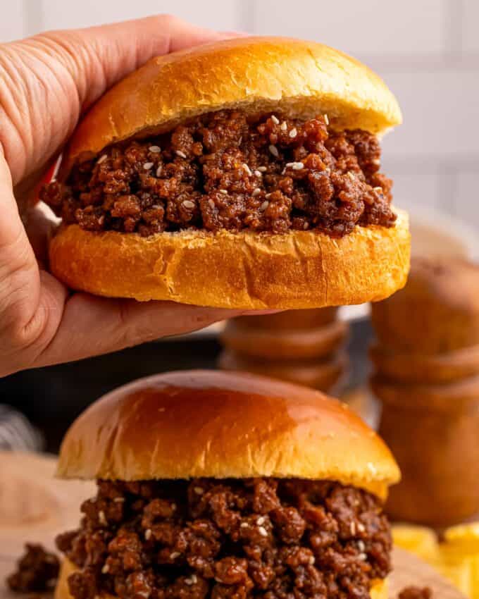 holding a sloppy joe sandwich.