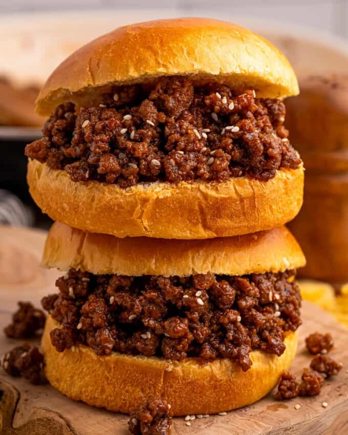 two sloppy joe sandwiches stacked on top of each other.