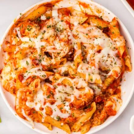 overhead photo of chicken parmesan casserole on white plate.