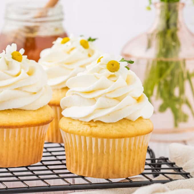 chamomile honey cupcakes on a wire cooling rack.