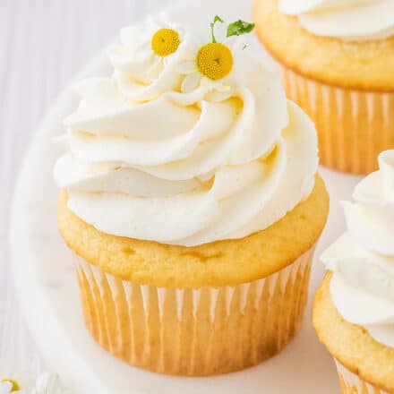 chamomile cupcakes with honey buttercream on a marble cake stand.