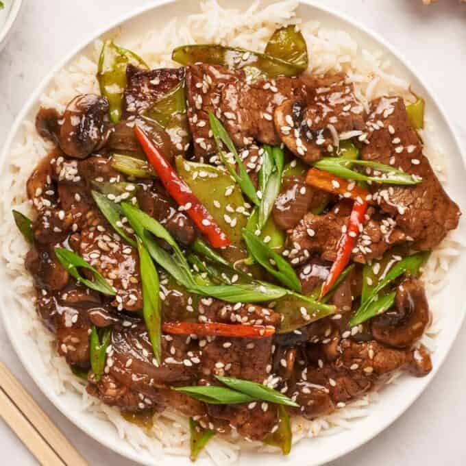 overhead photo of a white plate filled with white rice and a beef stir fry.