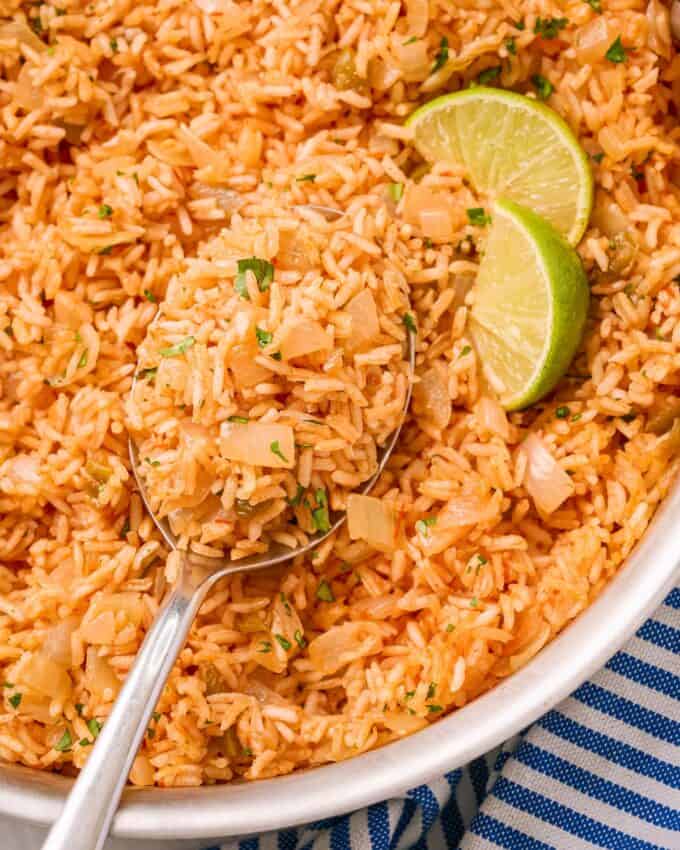 serving spoonful of mexican rice with onions
